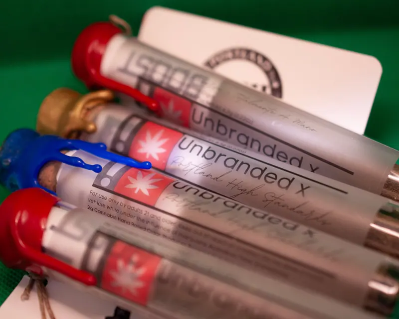 Row of product tubes with red and gold wax seals fanned across a green background, labels legible